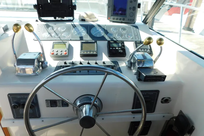 Slide: The Image of 1993 Tiara Yachts 3100 Open helm with steering wheel and control panel. - 40