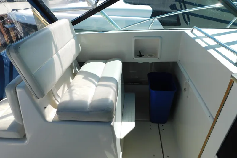 Slide: The Image of 1993 Tiara Yachts 3100 Open interior with white seating and blue trash bin. - 41