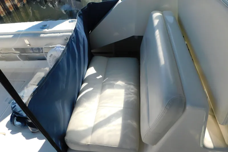Slide: The Image of 1993 Tiara Yachts 3100 Open interior seating with blue cover and white cushions. - 42