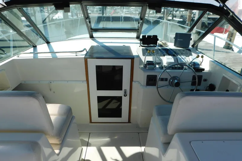 Slide: The Image of 1993 Tiara Yachts 3100 Open helm with steering wheel and navigation equipment. - 43