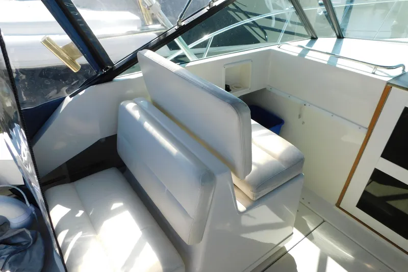 Slide: The Image of 1993 Tiara Yachts 3100 Open interior with white seating and helm area. - 44