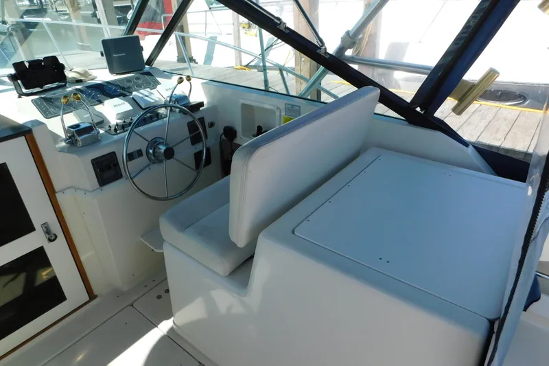 Slide: The Image of 1993 Tiara Yachts 3100 Open helm with steering wheel and control panel. - 45