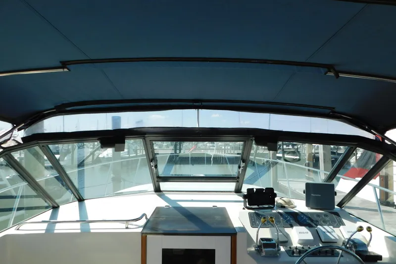 Slide: The Image of Interior view of 1993 Tiara Yachts 3100 Open helm with navigation equipment and marina backdrop. - 46