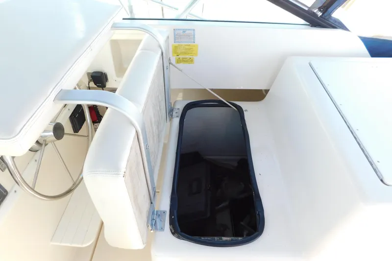 Slide: The Image of 1993 Tiara Yachts 3100 Open cockpit with white seating and storage compartment. - 48