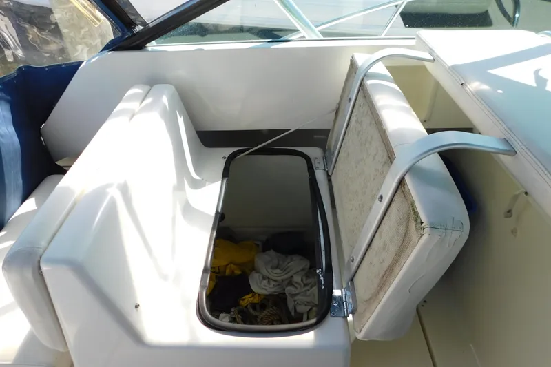 Slide: The Image of 1993 Tiara Yachts 3100 Open interior storage compartment with open seat and visible contents. - 49
