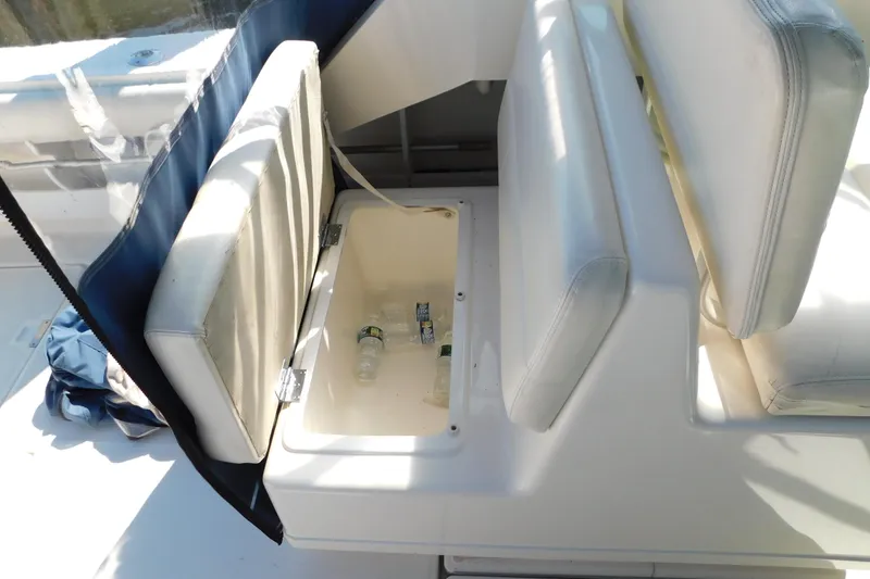 Slide: The Image of Storage compartment on a 1993 Tiara Yachts 3100 Open, with bottles inside. - 50