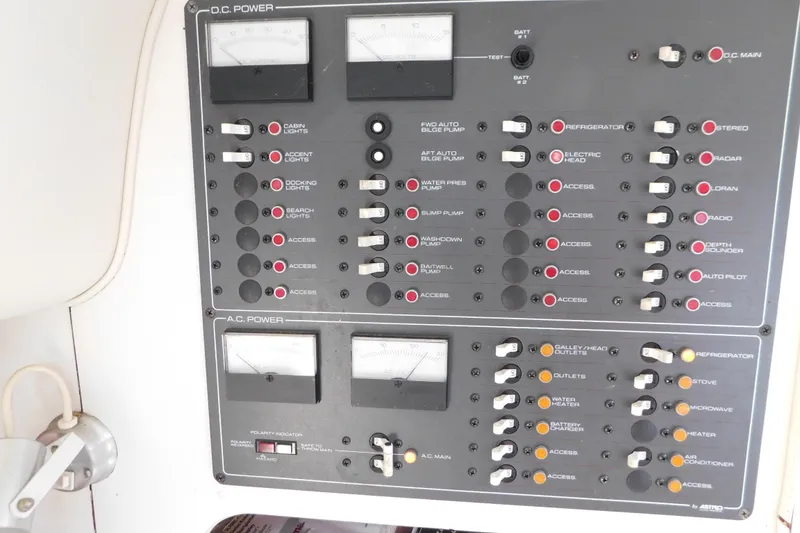 Slide: The Image of Control panel of a 1993 Tiara Yachts 3100 Open, featuring DC and AC power switches. - 56