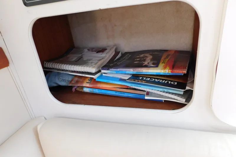 Slide: The Image of Storage compartment with magazines and notebooks on a 1993 Tiara Yachts 3100 Open. - 57