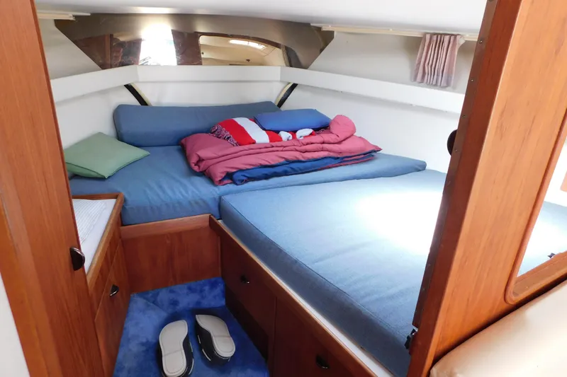 Slide: The Image of 1993 Tiara Yachts 3100 Open cabin interior with cozy bed and wooden furnishings. - 64