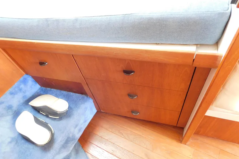 Slide: The Image of Wooden cabin drawers and blue carpet in 1993 Tiara Yachts 3100 Open. - 66