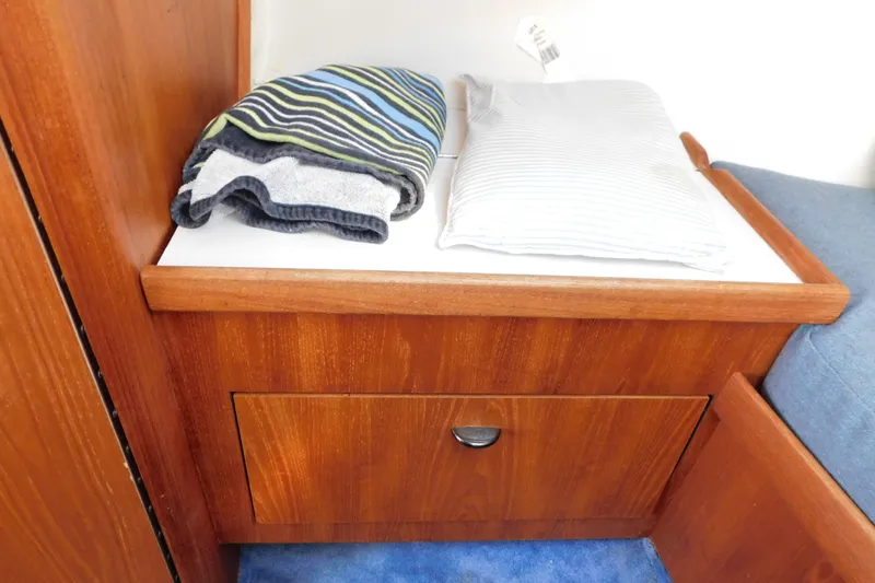 Slide: The Image of Wooden cabin interior of 1993 Tiara Yachts 3100 Open with folded towels and pillow. - 67