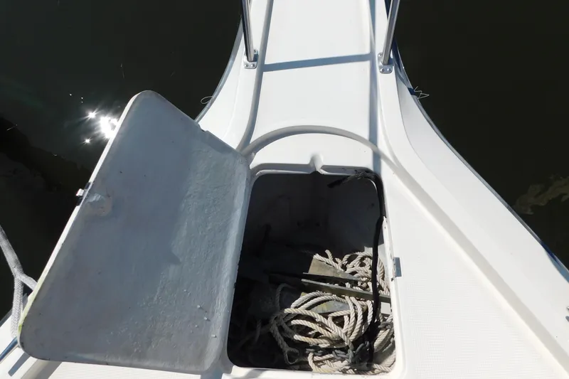 Slide: The Image of Open anchor locker on 1993 Tiara Yachts 3100 Open, showing ropes and anchor. - 7
