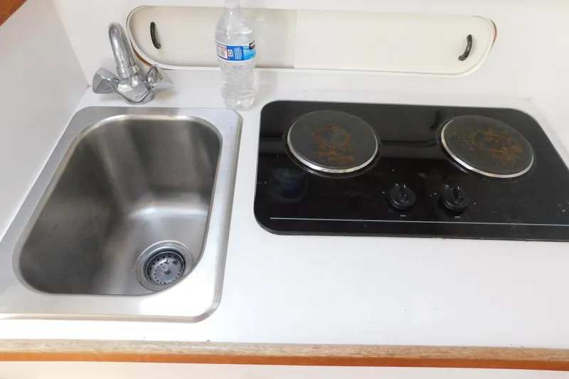 Slide: The Image of 1993 Tiara Yachts 3100 Open galley with sink and stovetop. - 71