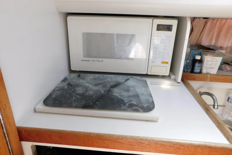 Slide: The Image of Microwave and countertop in 1993 Tiara Yachts 3100 Open galley area. - 73