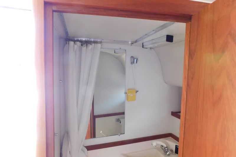Slide: The Image of Bathroom interior of 1993 Tiara Yachts 3100 Open with shower and sink. - 82