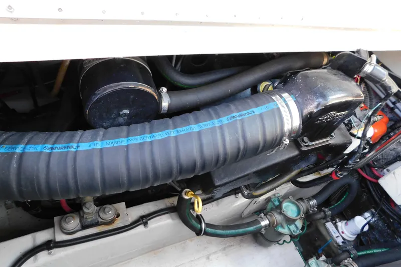 Slide: The Image of Engine compartment of a 1993 Tiara Yachts 3100 Open, featuring marine exhaust system components. - 89