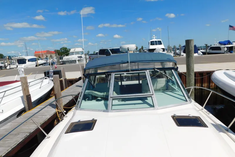 Slide: The Image of 1993 Tiara Yachts 3100 Open docked at marina under clear blue sky. - 9