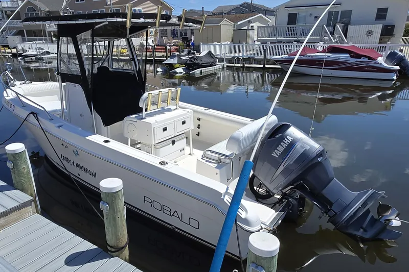 The Image of 2003 Robalo R230 Center Console boat docked with Yamaha outboard motor. - 0