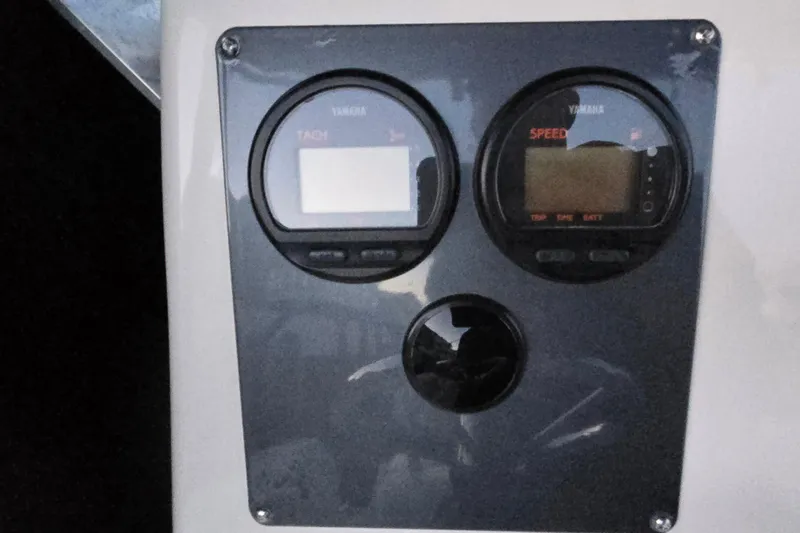 Slide: The Image of Yamaha tachometer and speedometer on 2003 Robalo R230 Center Console boat dashboard. - 10