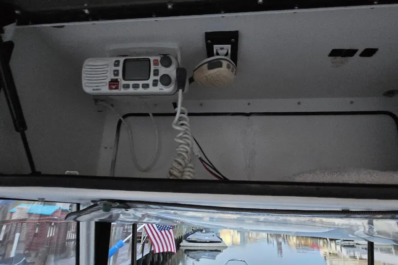 Slide: The Image of 2003 Robalo R230 Center Console boat with marine radio and speaker installed. - 12