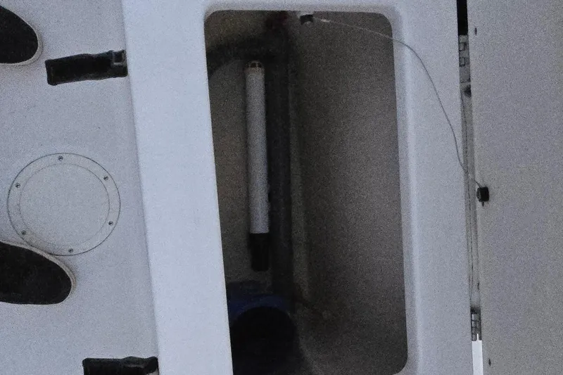 Slide: The Image of Storage compartment of a 2003 Robalo R230 Center Console boat. - 13