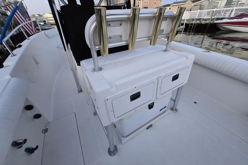 Slide: The Image of 2003 Robalo R230 Center Console boat interior with rod holders and storage compartments. - 6