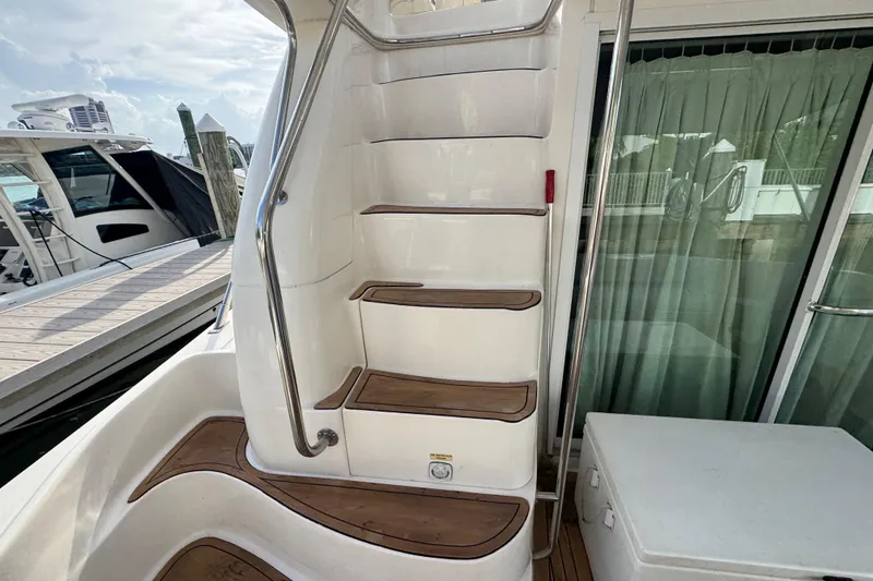 Slide: The Image of Staircase on 1998 Sea Ray 480 Sedan Bridge yacht with wooden steps and railing. - 10