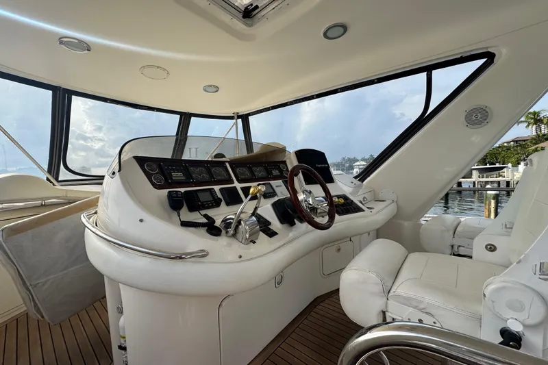 Slide: The Image of 1998 Sea Ray 480 Sedan Bridge helm with modern controls and panoramic windows. - 11