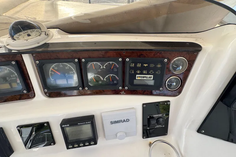 Slide: The Image of Control panel of a 1998 Sea Ray 480 Sedan Bridge with gauges and navigation equipment. - 18