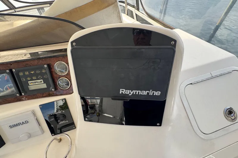 Slide: The Image of 1998 Sea Ray 480 Sedan Bridge helm with Raymarine and Caterpillar controls. - 19