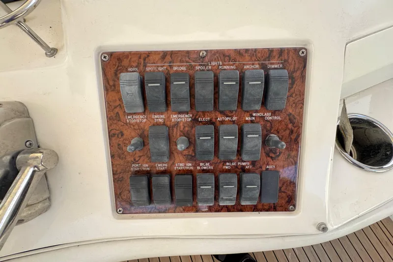 Slide: The Image of Control panel of a 1998 Sea Ray 480 Sedan Bridge yacht with various switches. - 24