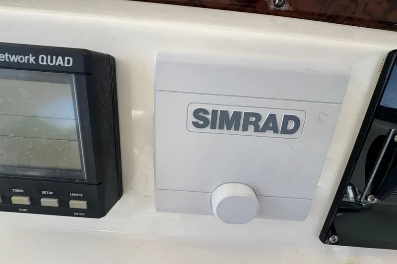 Slide: The Image of Simrad marine electronics on 1998 Sea Ray 480 Sedan Bridge dashboard. - 26