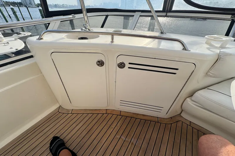 Slide: The Image of Interior view of a 1998 Sea Ray 480 Sedan Bridge yacht with wooden flooring. - 42