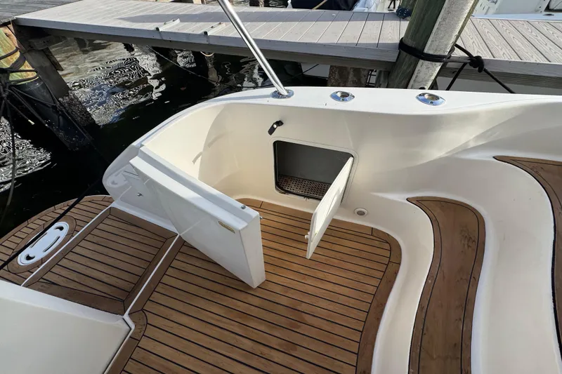 Slide: The Image of 1998 Sea Ray 480 Sedan Bridge boat deck with open storage compartment. - 46