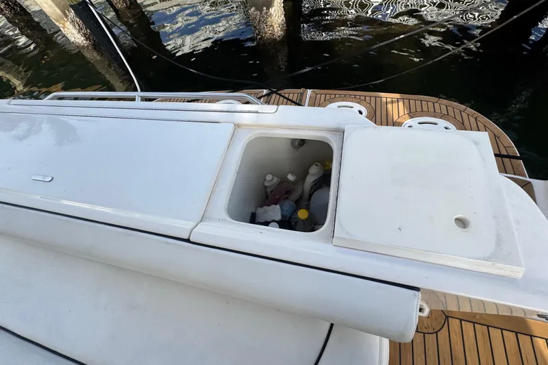 Slide: The Image of 1998 Sea Ray 480 Sedan Bridge with open storage compartment on deck. - 48