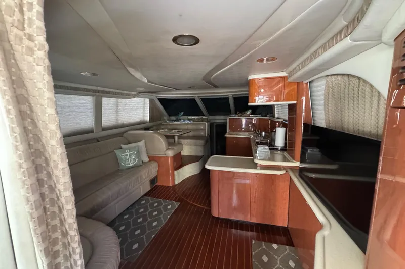 Slide: The Image of Luxurious interior of a 1998 Sea Ray 480 Sedan Bridge yacht with elegant wood finishes. - 54