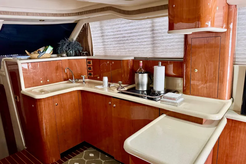 Slide: The Image of Luxurious 1998 Sea Ray 480 Sedan Bridge yacht interior with elegant wooden cabinetry. - 58