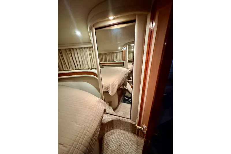 Slide: The Image of Interior cabin of 1998 Sea Ray 480 Sedan Bridge yacht with cozy bedding. - 60