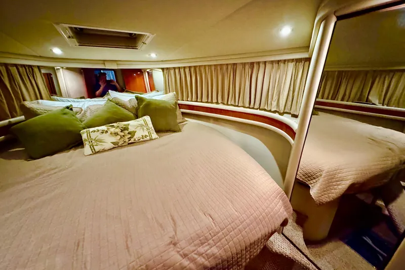 Slide: The Image of Luxurious bedroom interior of 1998 Sea Ray 480 Sedan Bridge yacht with cozy bedding. - 61