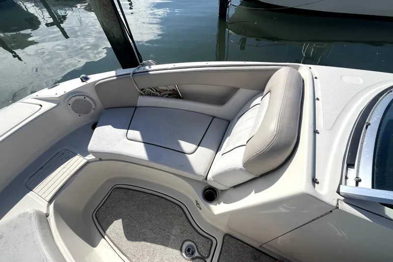 Slide: The Image of 2010 Sea Ray 220 Sundeck boat interior with cushioned seating and speaker. - 10
