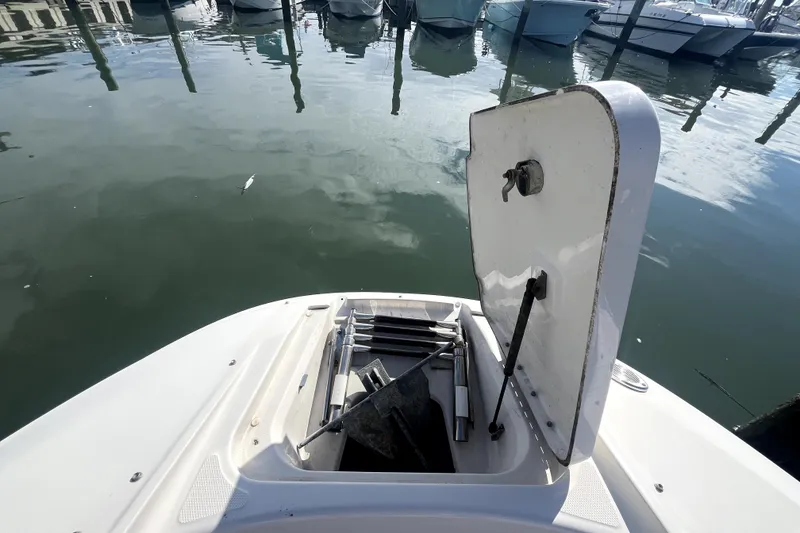 Slide: The Image of Open storage compartment on 2010 Sea Ray 220 Sundeck boat, docked at marina. - 14
