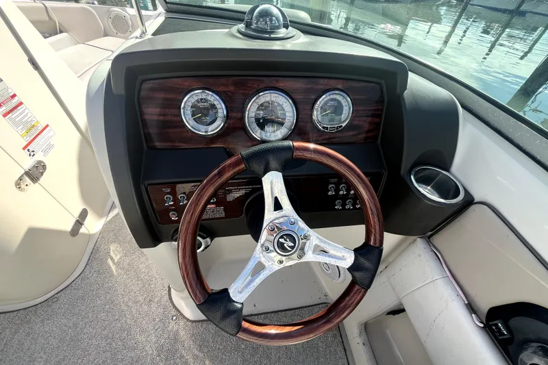 Slide: The Image of Steering wheel and dashboard of 2010 Sea Ray 220 Sundeck boat. - 19