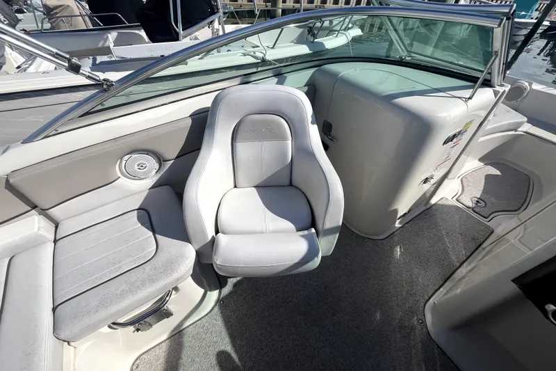Slide: The Image of 2010 Sea Ray 220 Sundeck interior with white seating and sleek design. - 20