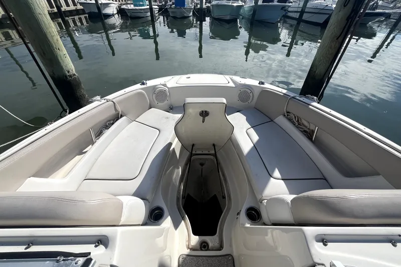 Slide: The Image of 2010 Sea Ray 220 Sundeck interior with seating, docked at marina. - 9