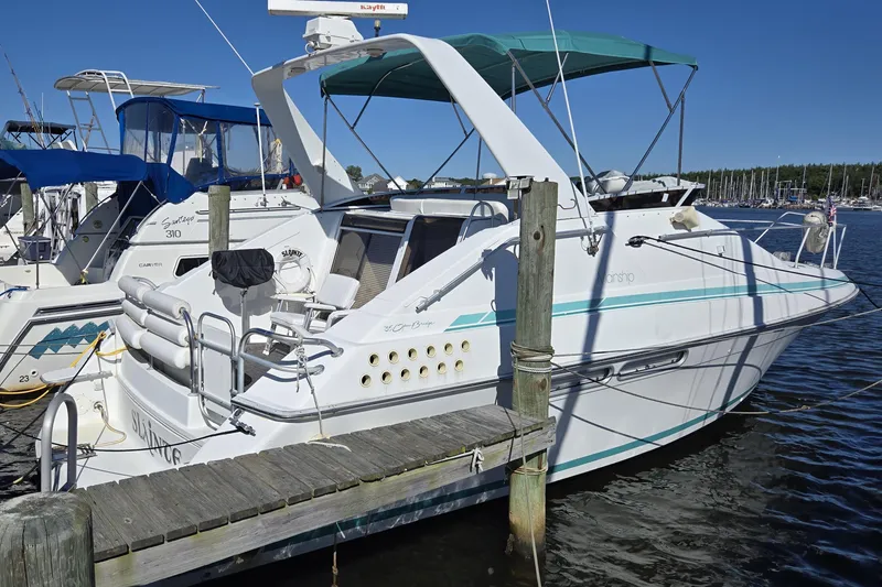 Slide: The Image of 1991 Mainship 35 Open Bridge yacht docked at marina under clear blue sky. - 1