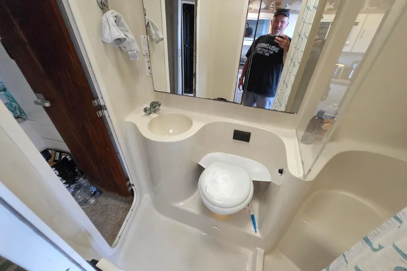 Slide: The Image of Bathroom interior of 1991 Mainship 35 Open Bridge yacht with sink and mirror. - 15