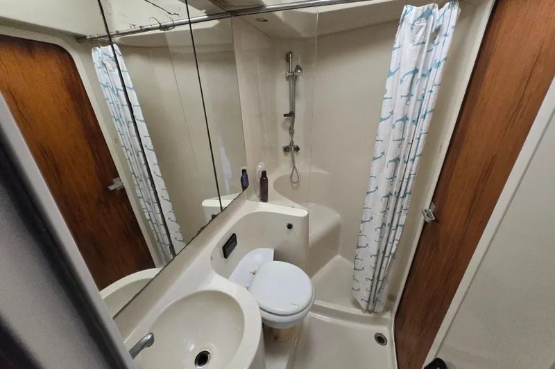 Slide: The Image of Bathroom interior of 1991 Mainship 35 Open Bridge yacht, featuring shower and sink. - 16