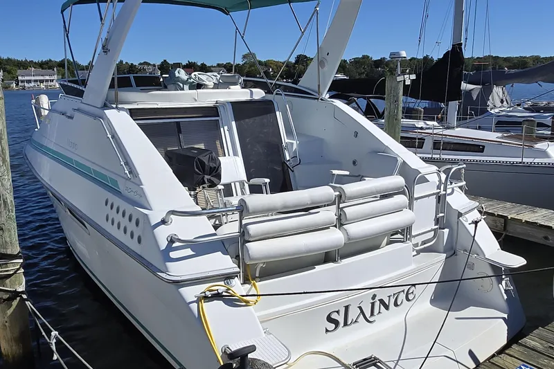 Slide: The Image of 1991 Mainship 35 Open Bridge yacht docked at marina, rear view. - 2