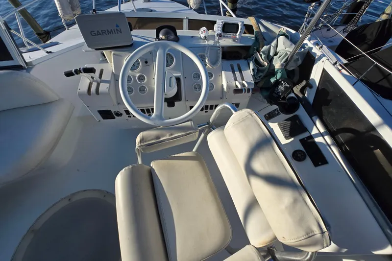 Slide: The Image of 1991 Mainship 35 Open Bridge helm with Garmin navigation system and controls. - 21
