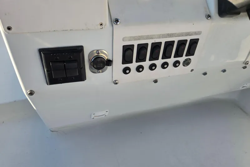 Slide: The Image of Control panel of a 1991 Mainship 35 Open Bridge boat with switches and dials. - 28